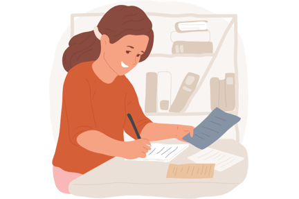 Student sitting at a desk holding a paper and writing on another paper while doing school work