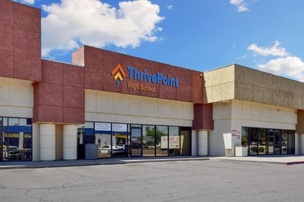 The front of the outside of a school campus building during the daytime that shows the sign of the campus